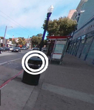 This is an image from the spot the surveillance application. There is a trash can with two white circles around it.