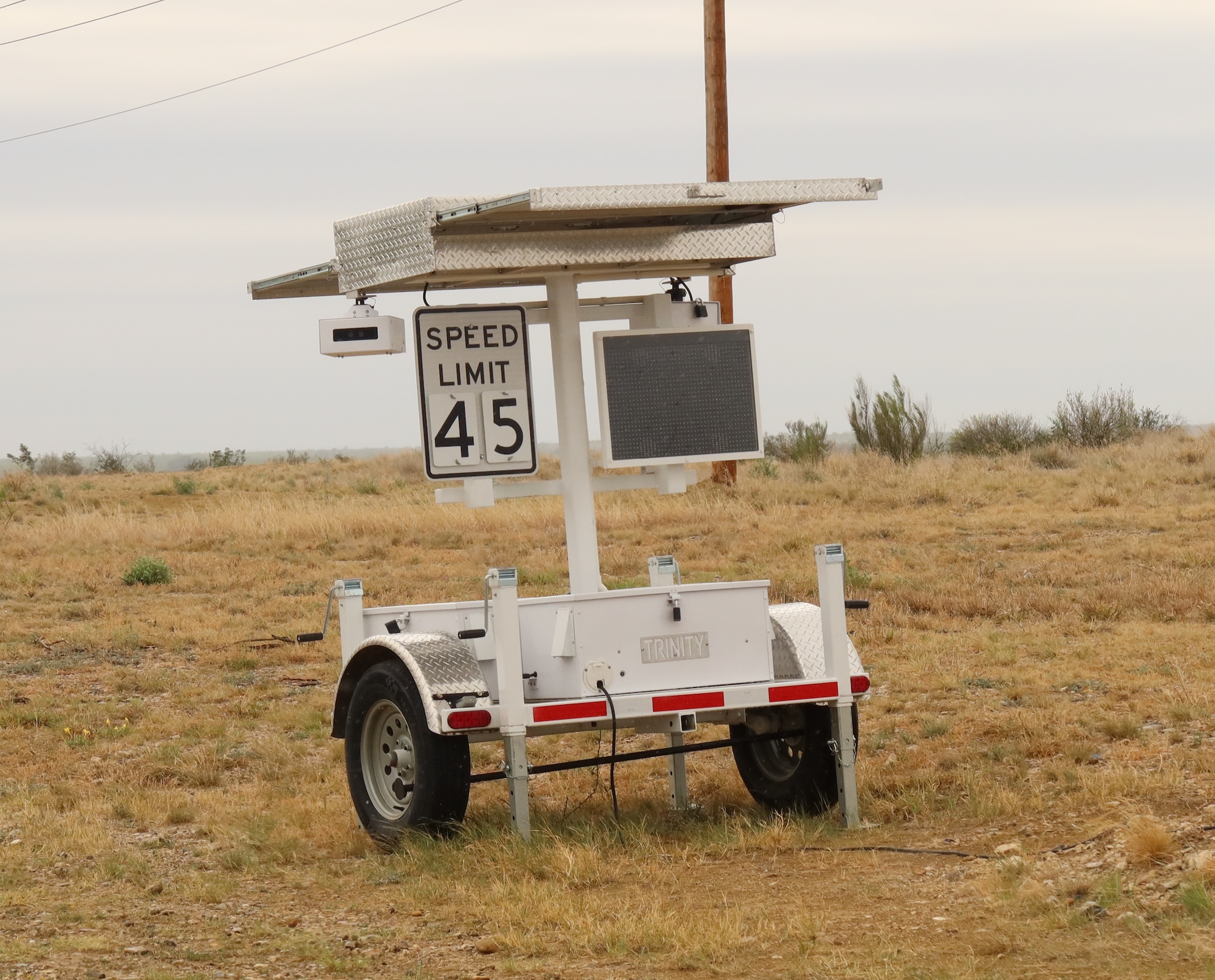 A speed trailer capturing ALPR. Speed limit 45 sign. A speed trailer capturing ALPR. Speed limit 45 sign.