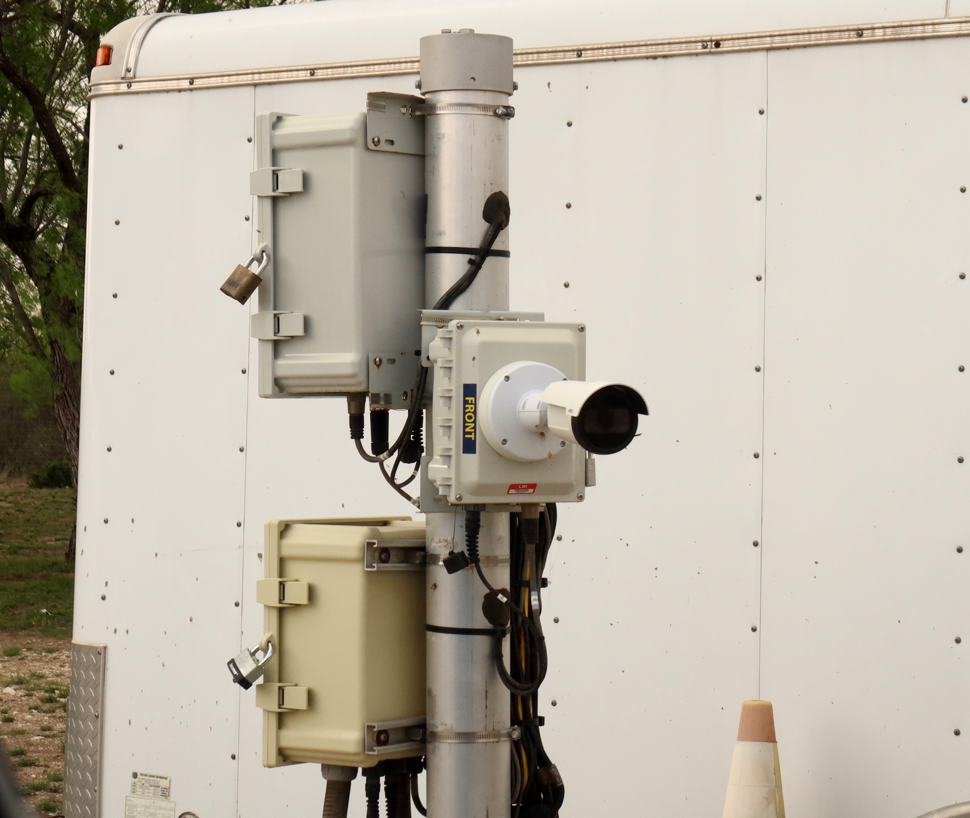Close up of a camera marked "Front." Close up of a camera marked "Front."