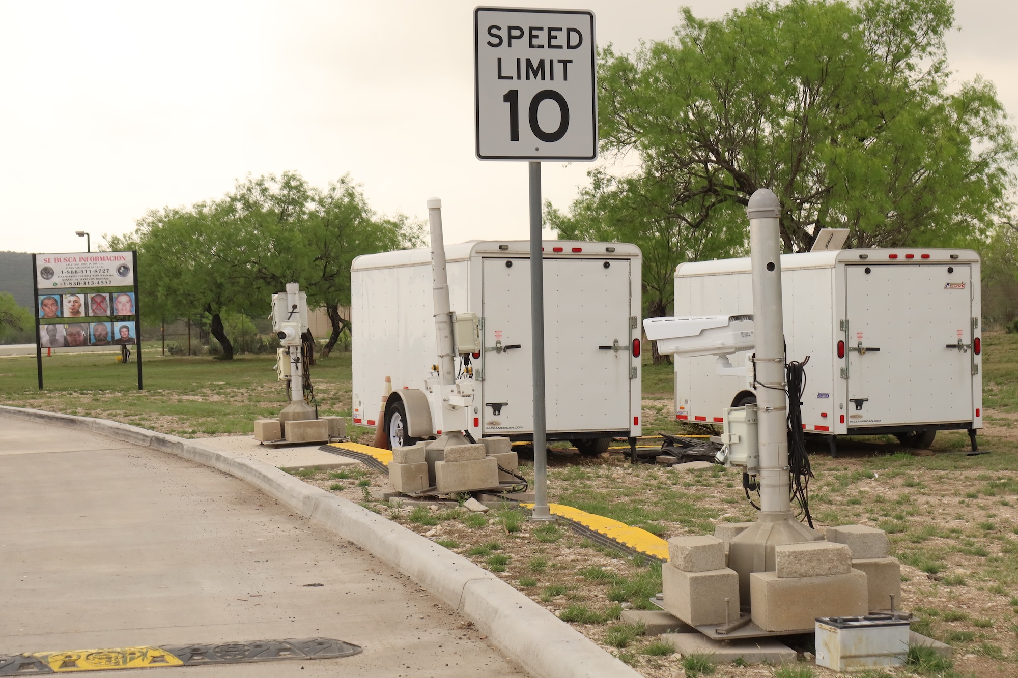 ALPR cameras next to white trailers along the lane into a checkpoint ALPR cameras next to white trailers along the lane into a checkpoint