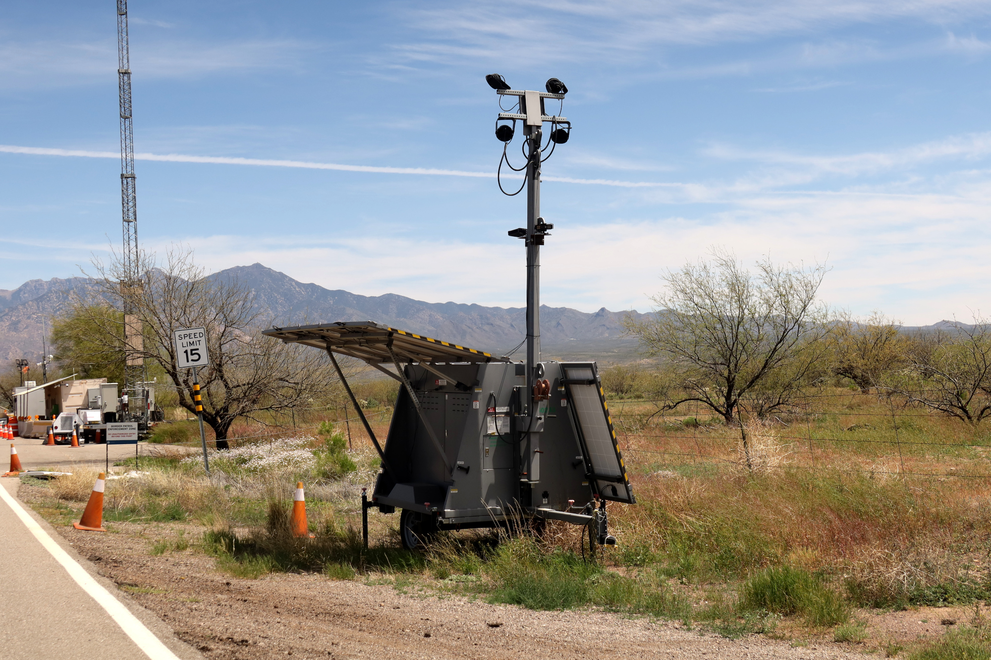 A trailer with a pole with mounted ALPR cameras in the desert. A trailer with a pole with mounted ALPR cameras in the desert.