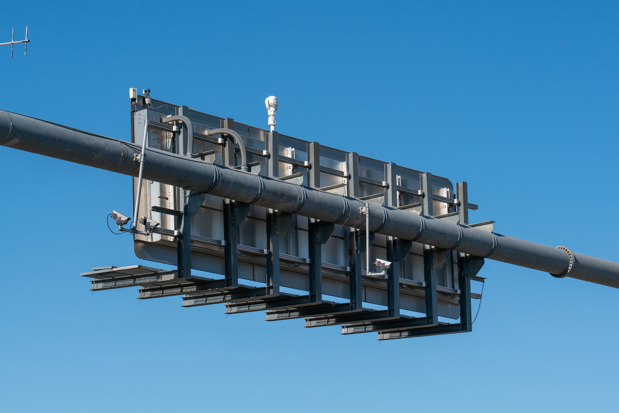 The back of a highway overpass sign with ALPR cameras. The back of a highway overpass sign with ALPR cameras.